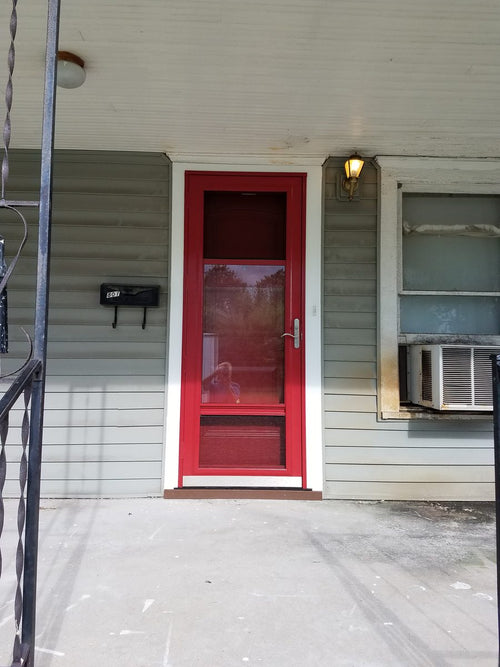 StrongJamb-reinforced red entry door on a rental home